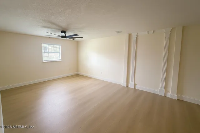 a view of an empty room with a window