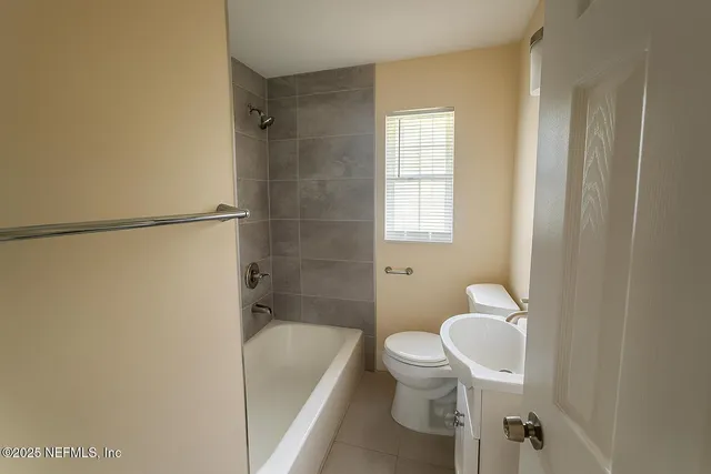 a bathroom with a toilet and a bathtub