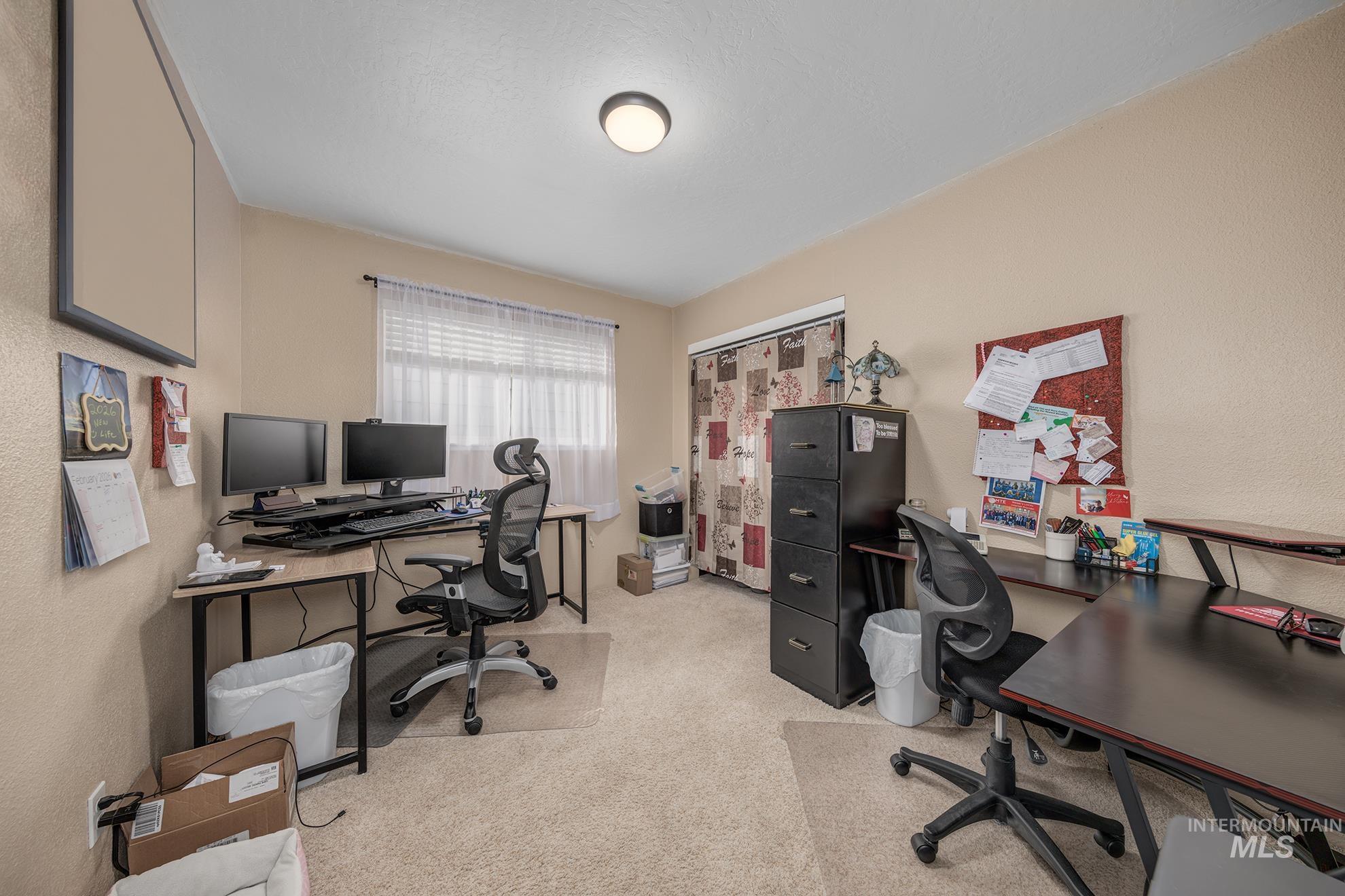 611 West Indianhead Road Weiser, ID 83672 - Photo 15 of 34 Office area with light carpet and a textured wall