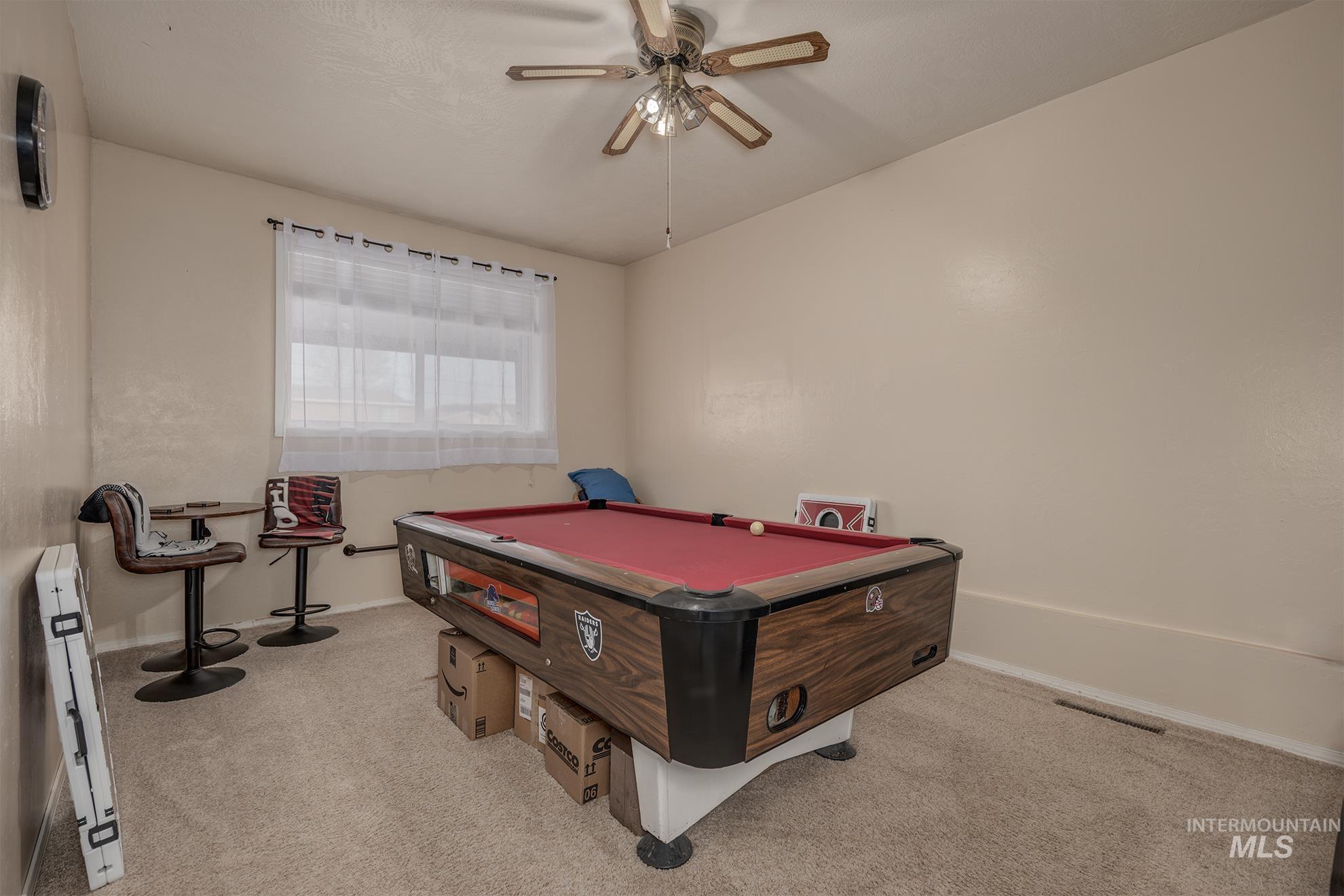 611 West Indianhead Road Weiser, ID 83672 - Photo 21 of 34 Rec room with pool table, light carpet, ceiling fan, and a baseboard heating unit
