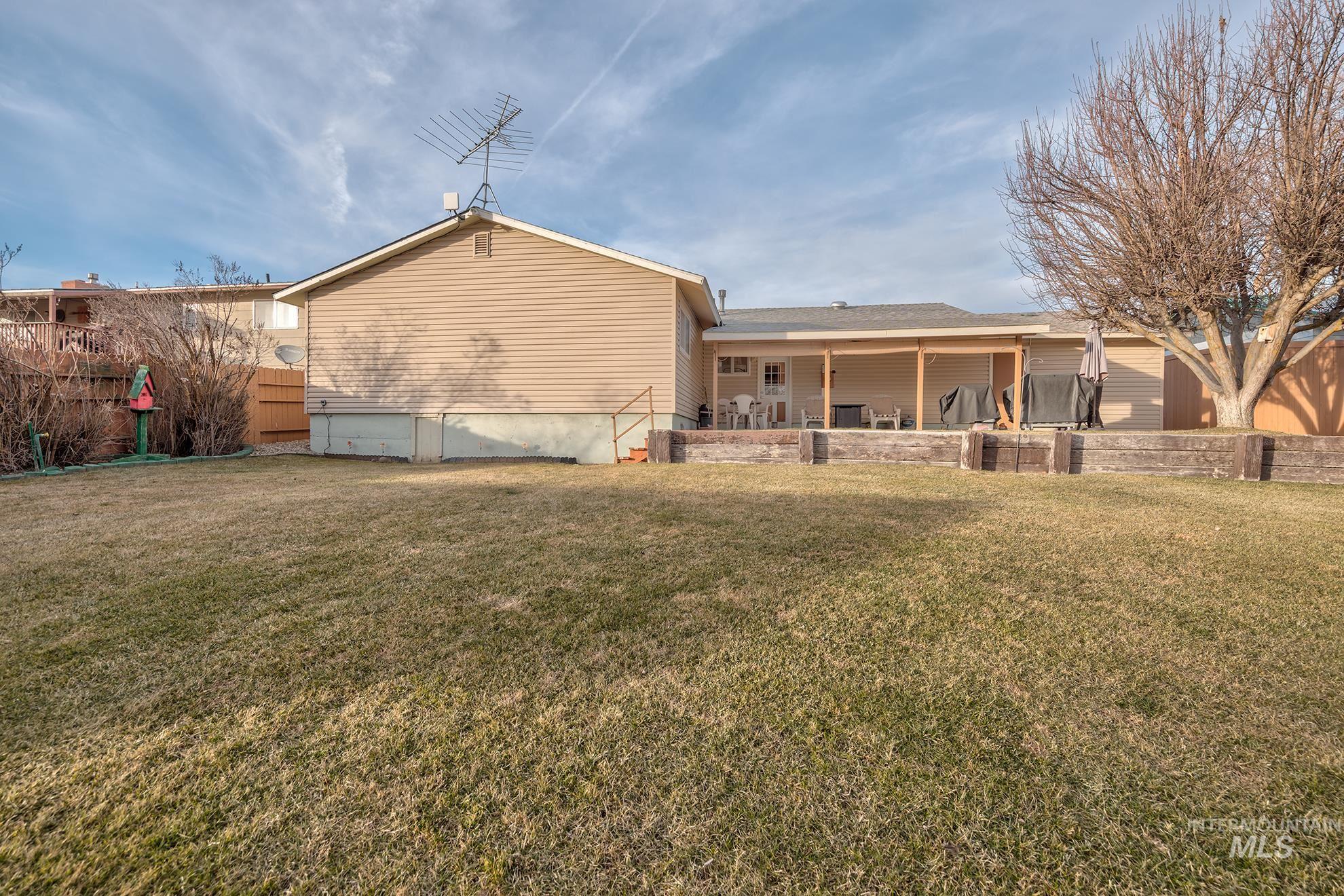611 West Indianhead Road Weiser, ID 83672 - Photo 26 of 34 Rear view of house with a patio area