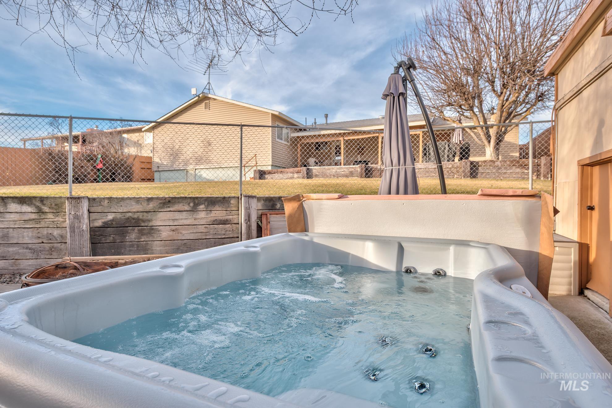 611 West Indianhead Road Weiser, ID 83672 - Photo 30 of 34 View of pool featuring a fenced backyard and a hot tub