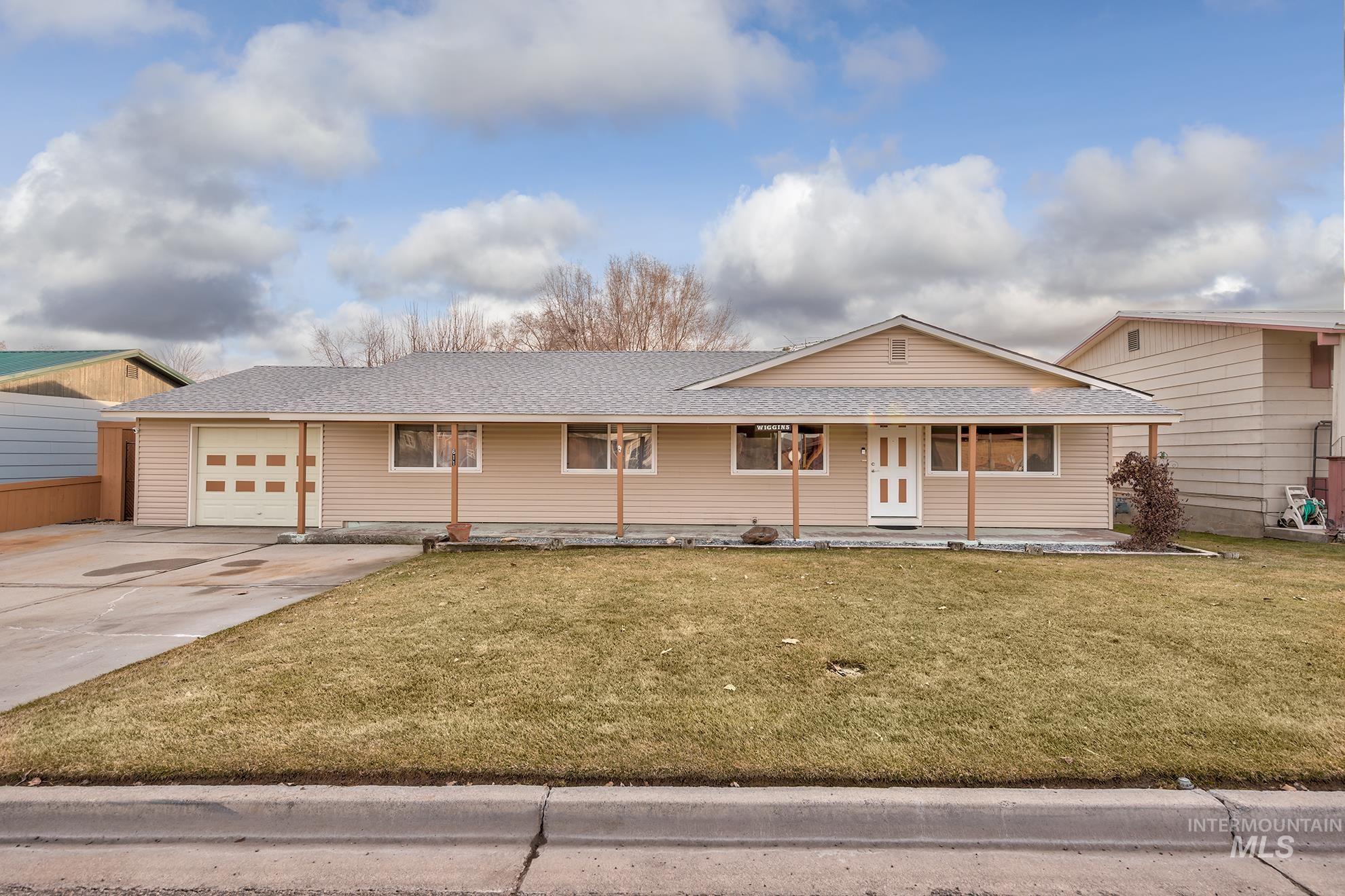 611 West Indianhead Road Weiser, ID 83672 - Photo 34 of 34 View of front of property with roof with shingles, a front yard, driveway, covered porch, and an attached garage