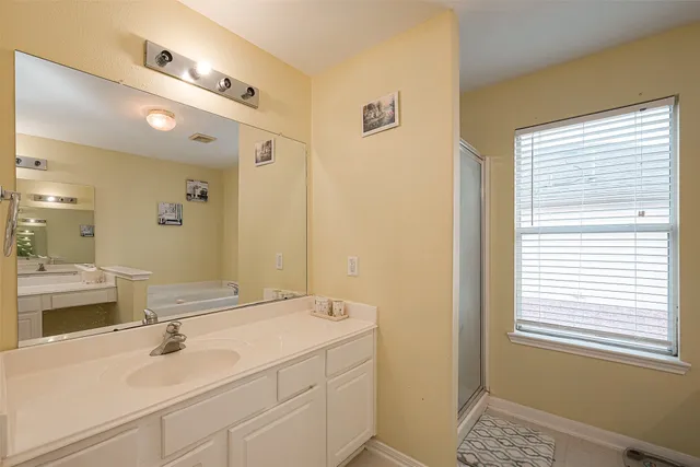 a bathroom with a tub and a sink