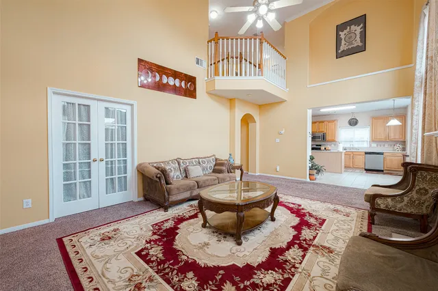 a living room with furniture and a chandelier