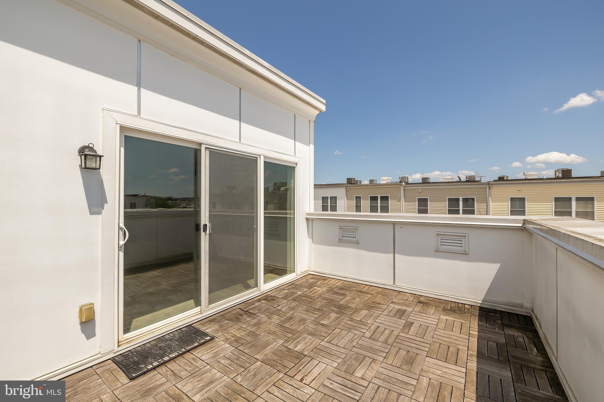 908 3rd Place Southeast Washington, DC 20003 - Photo 25 of 26 a view of a balcony with wooden floor and a potted plant