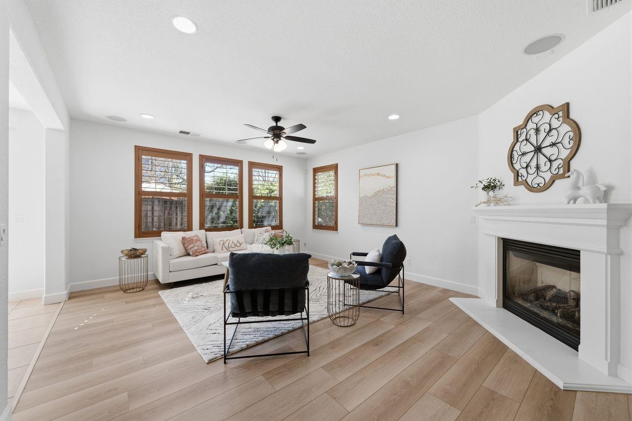 698 West Rico Way Tracy, CA 95391 - Photo 12 of 48 a living room with furniture a window and a fireplace