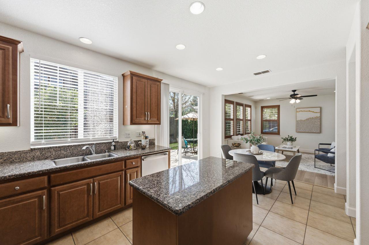 698 West Rico Way Tracy, CA 95391 - Photo 17 of 48 a kitchen with granite countertop sink and stove