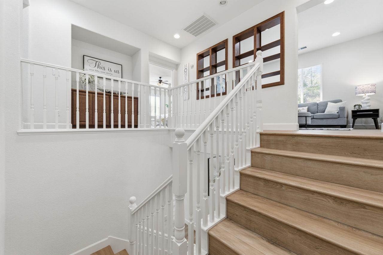 698 West Rico Way Tracy, CA 95391 - Photo 23 of 48 a view of staircase with lots of frames on wall and a window