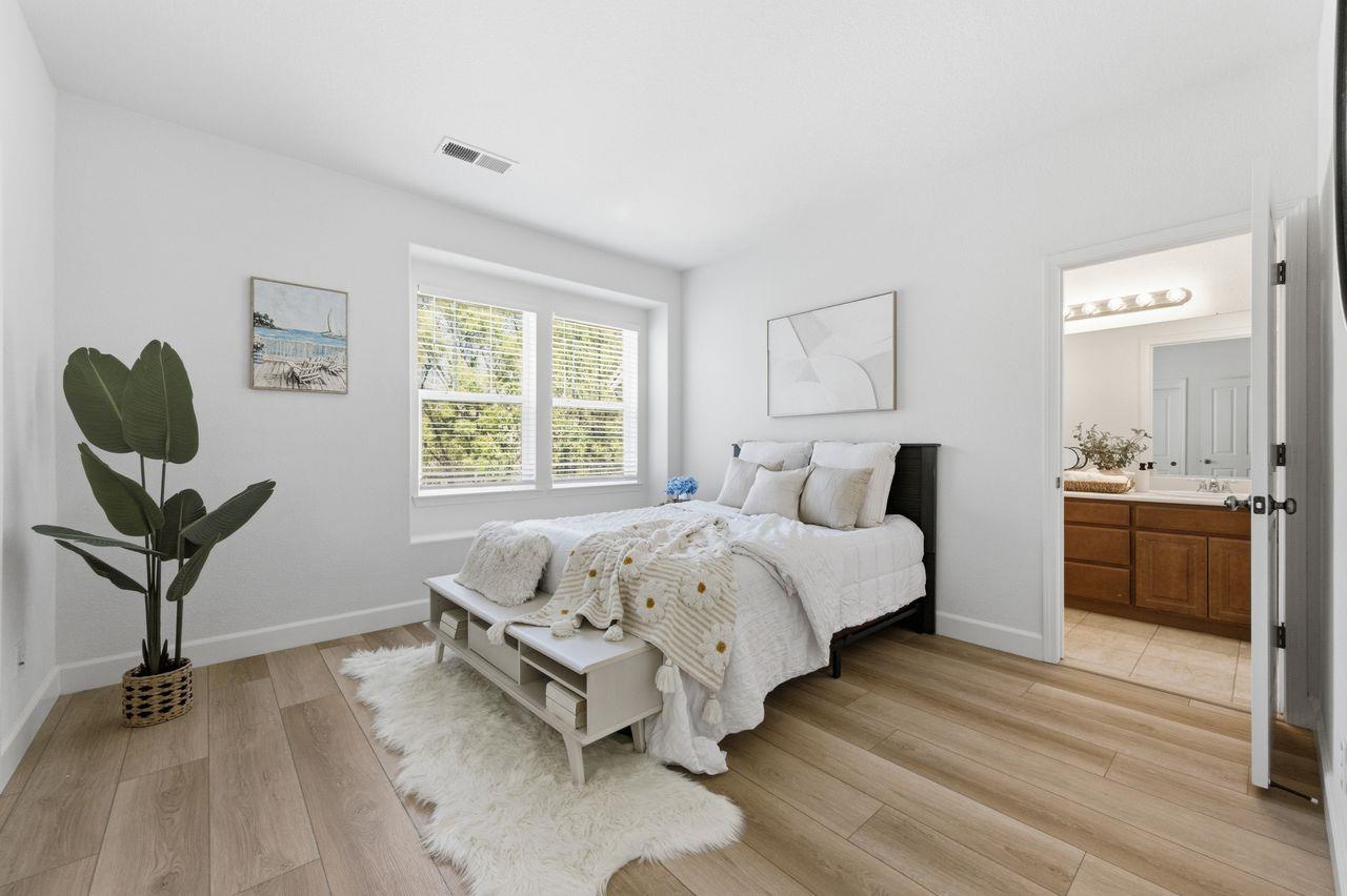 698 West Rico Way Tracy, CA 95391 - Photo 32 of 48 a bedroom with a bed and a chandelier