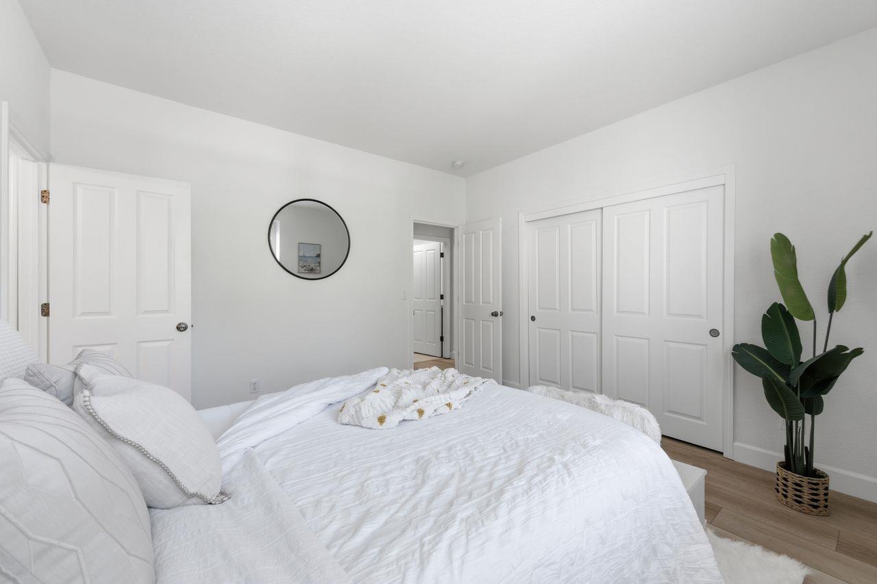 698 West Rico Way Tracy, CA 95391 - Photo 33 of 48 a bedroom with a bed and a potted plant