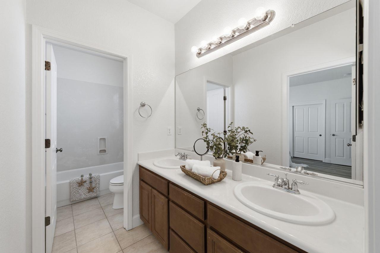 698 West Rico Way Tracy, CA 95391 - Photo 36 of 48 a bathroom with a sink and a mirror
