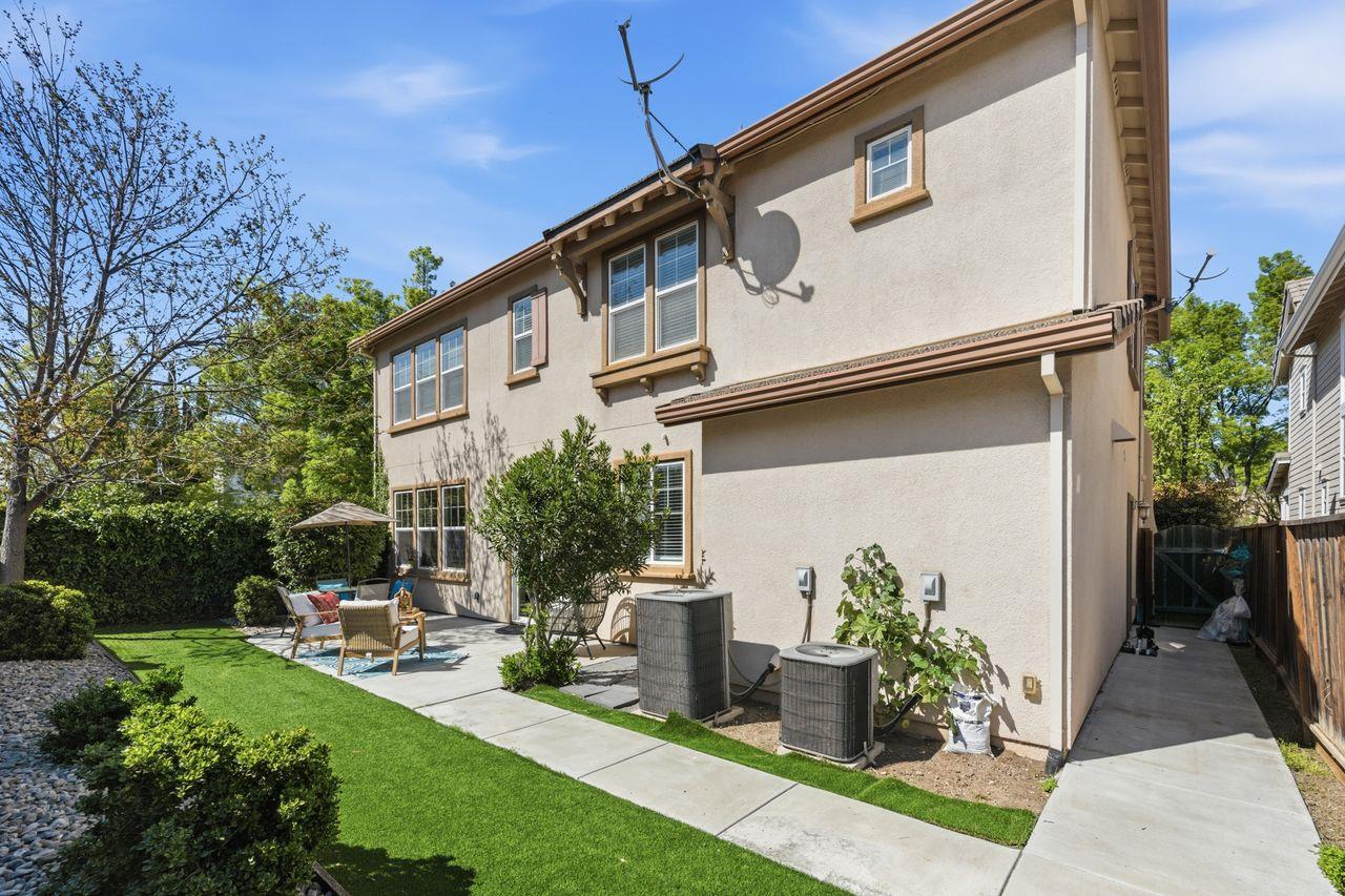 698 West Rico Way Tracy, CA 95391 - Photo 47 of 48 a backyard of a house with table and chairs plants and large trees