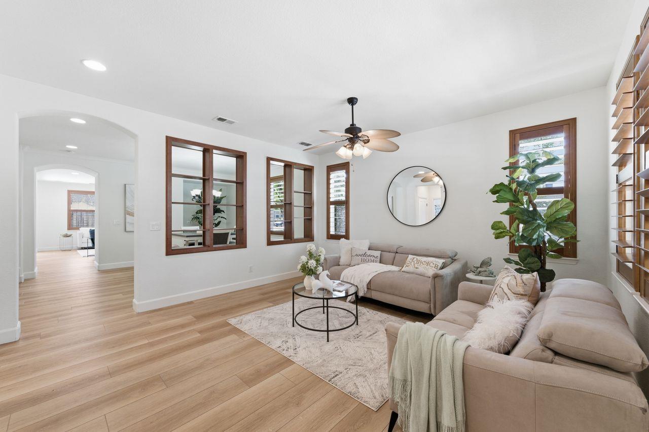 698 West Rico Way Tracy, CA 95391 - Photo 6 of 48 a living room with furniture a window and a chandelier