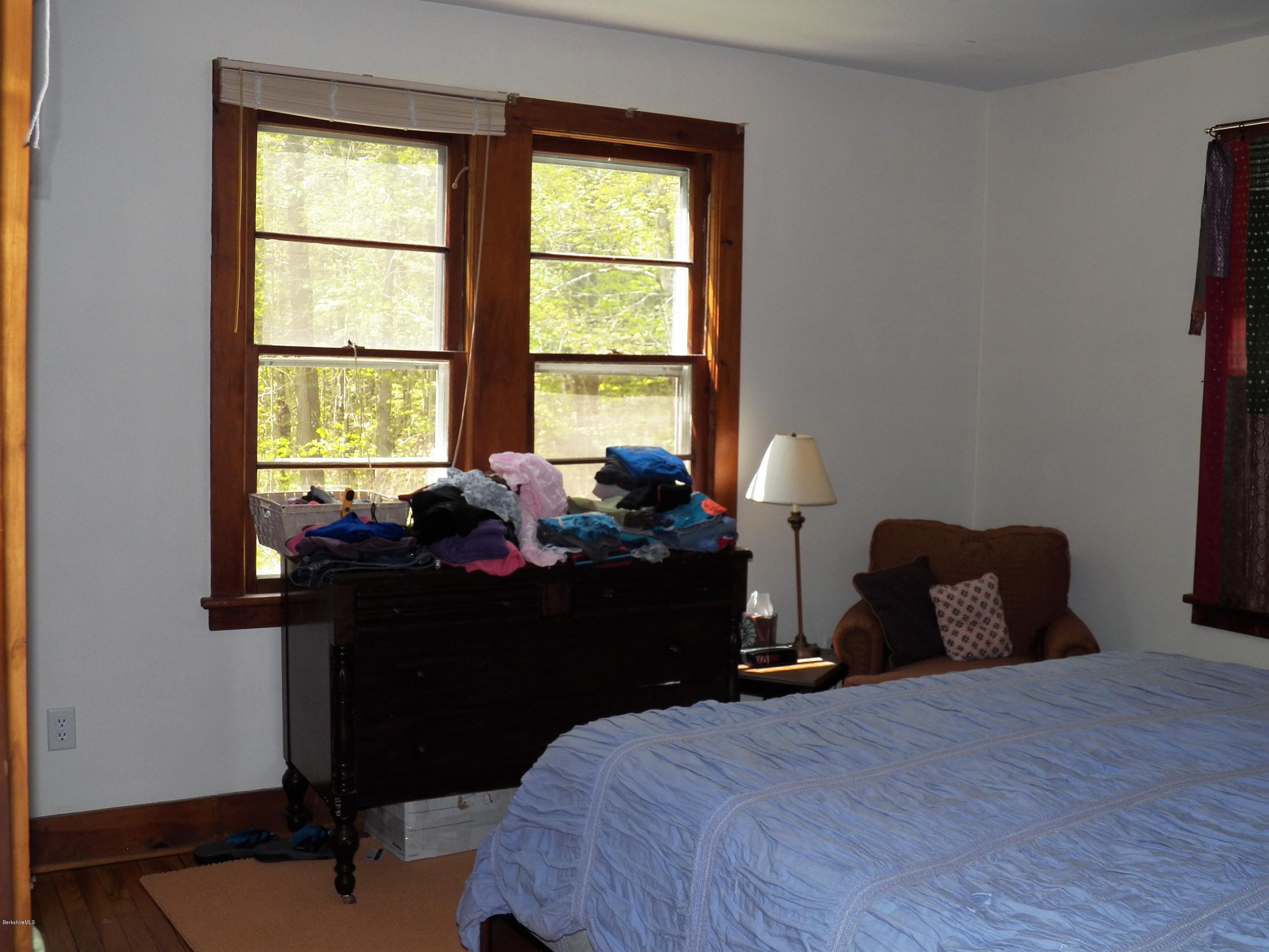 54 Sandisfield Road Monterey, MA 01245 - Photo 11 of 13 a bed room with a bed and a window