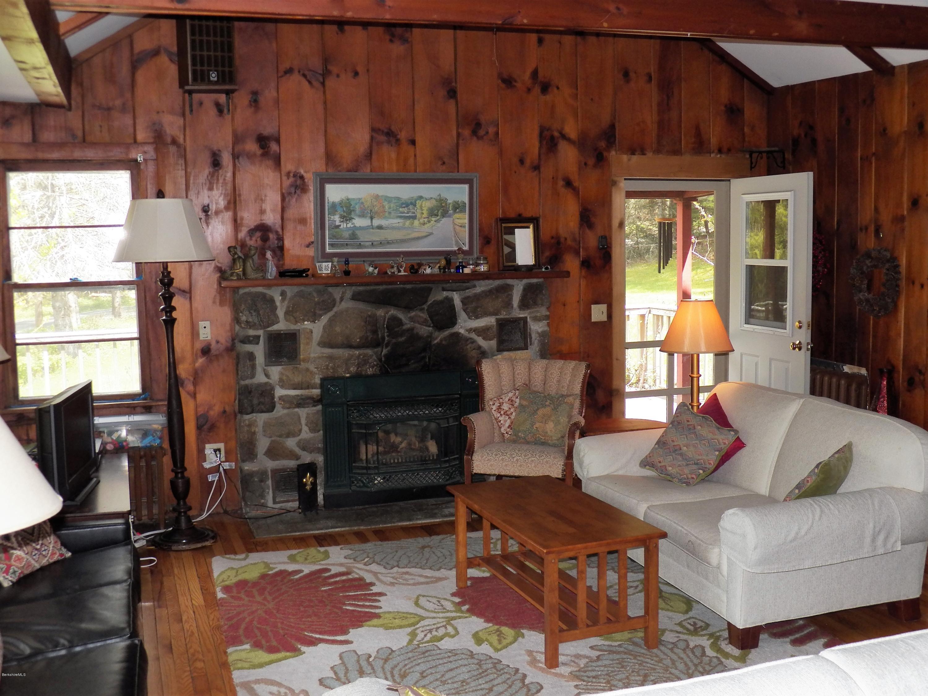54 Sandisfield Road Monterey, MA 01245 - Photo 6 of 13 a living room with furniture a flat screen tv and a fireplace