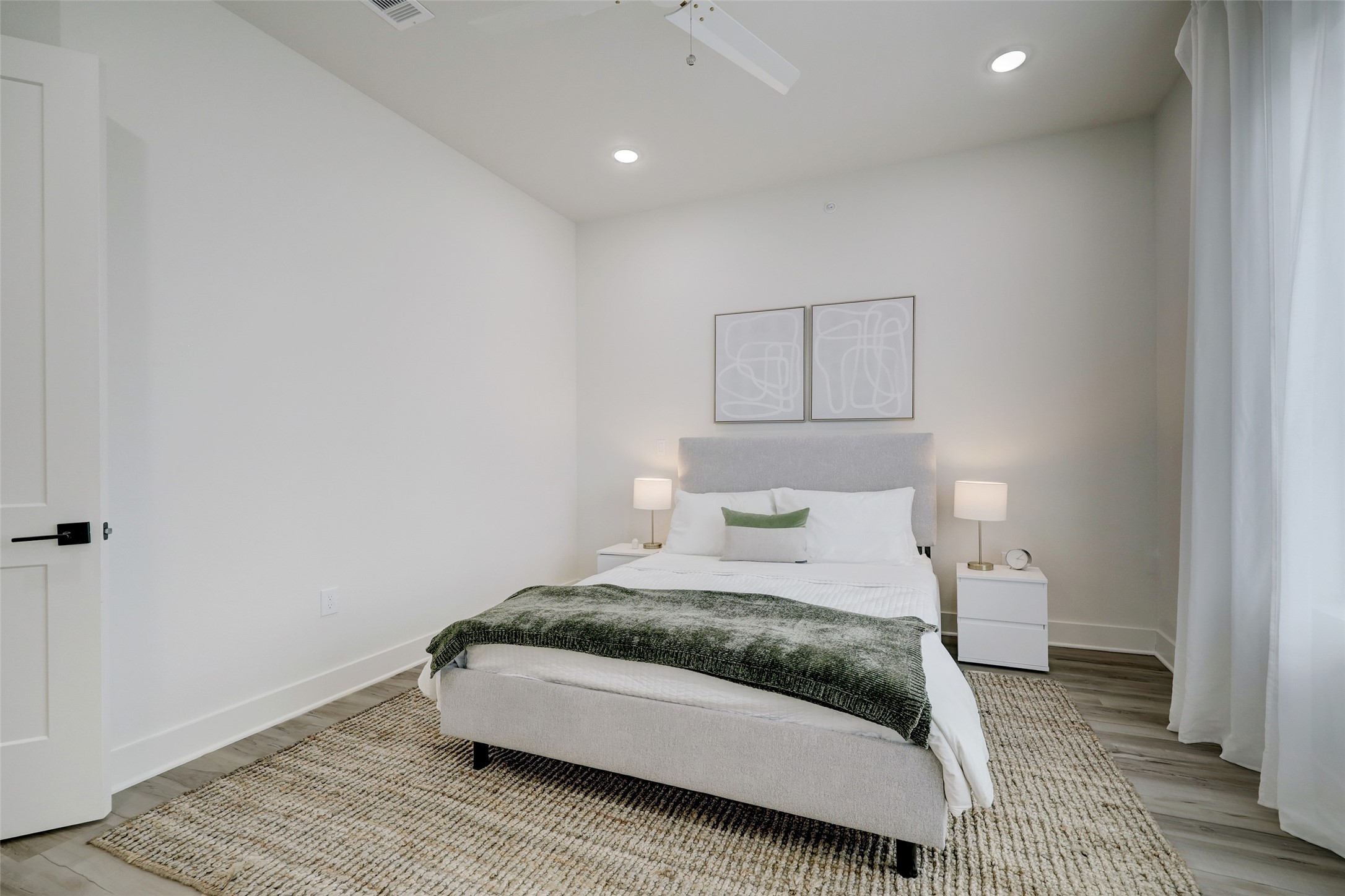 4932 Old Spanish Trail, Unit D301 Houston, TX 77021 - Photo 18 of 29 a bedroom with a bed and a night stand