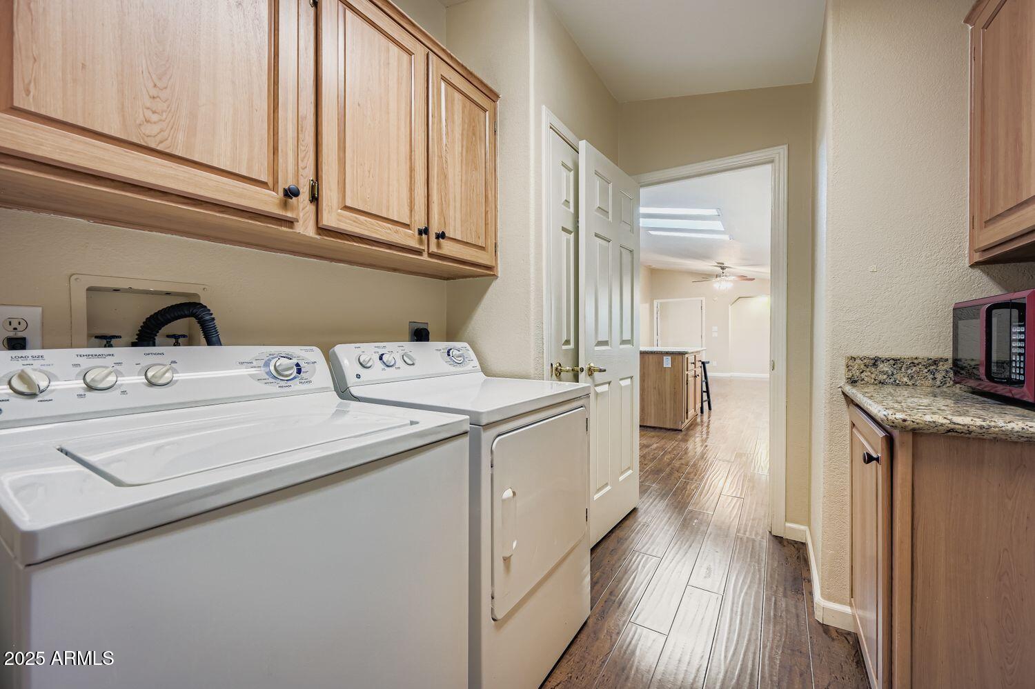 2550 South Ellsworth Road, Unit 277 Mesa, AZ 85209 - Photo 19 of 21 a utility room with cabinets washer and dryer