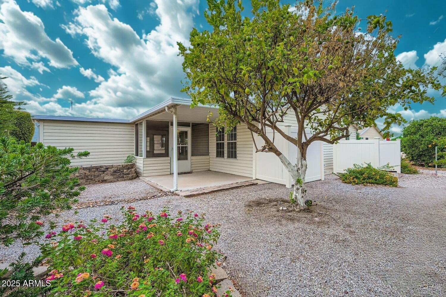 2550 South Ellsworth Road, Unit 277 Mesa, AZ 85209 - Photo 20 of 21 a front view of a house with a garden
