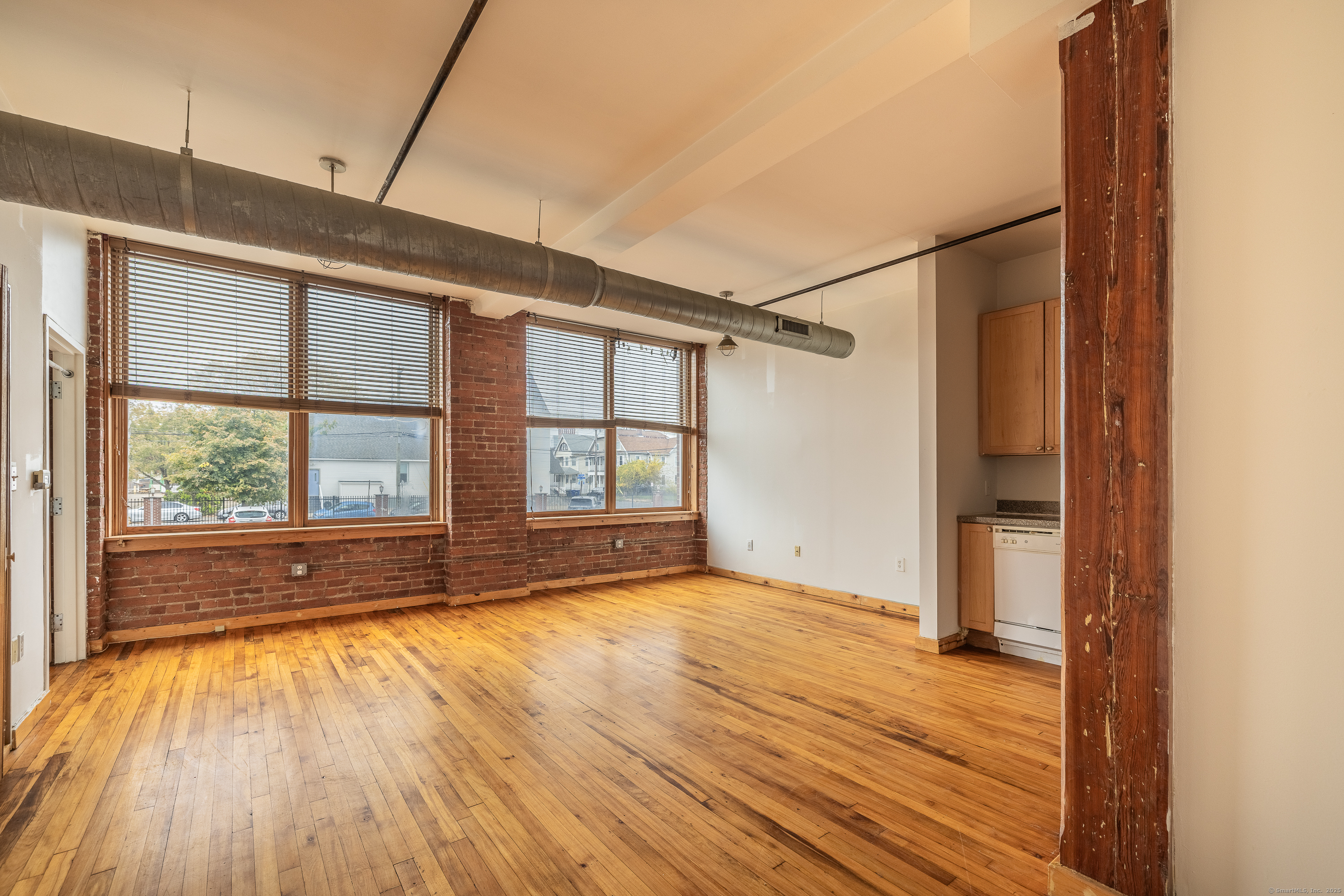 325 Lafayette Street, Unit 8102 Bridgeport, CT 06604 - Photo 1 of 19 a view of an empty room with wooden floor and a window
