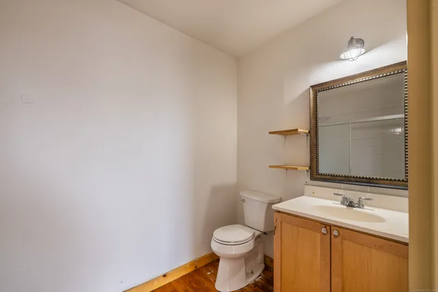 a bathroom with a sink a toilet and mirror