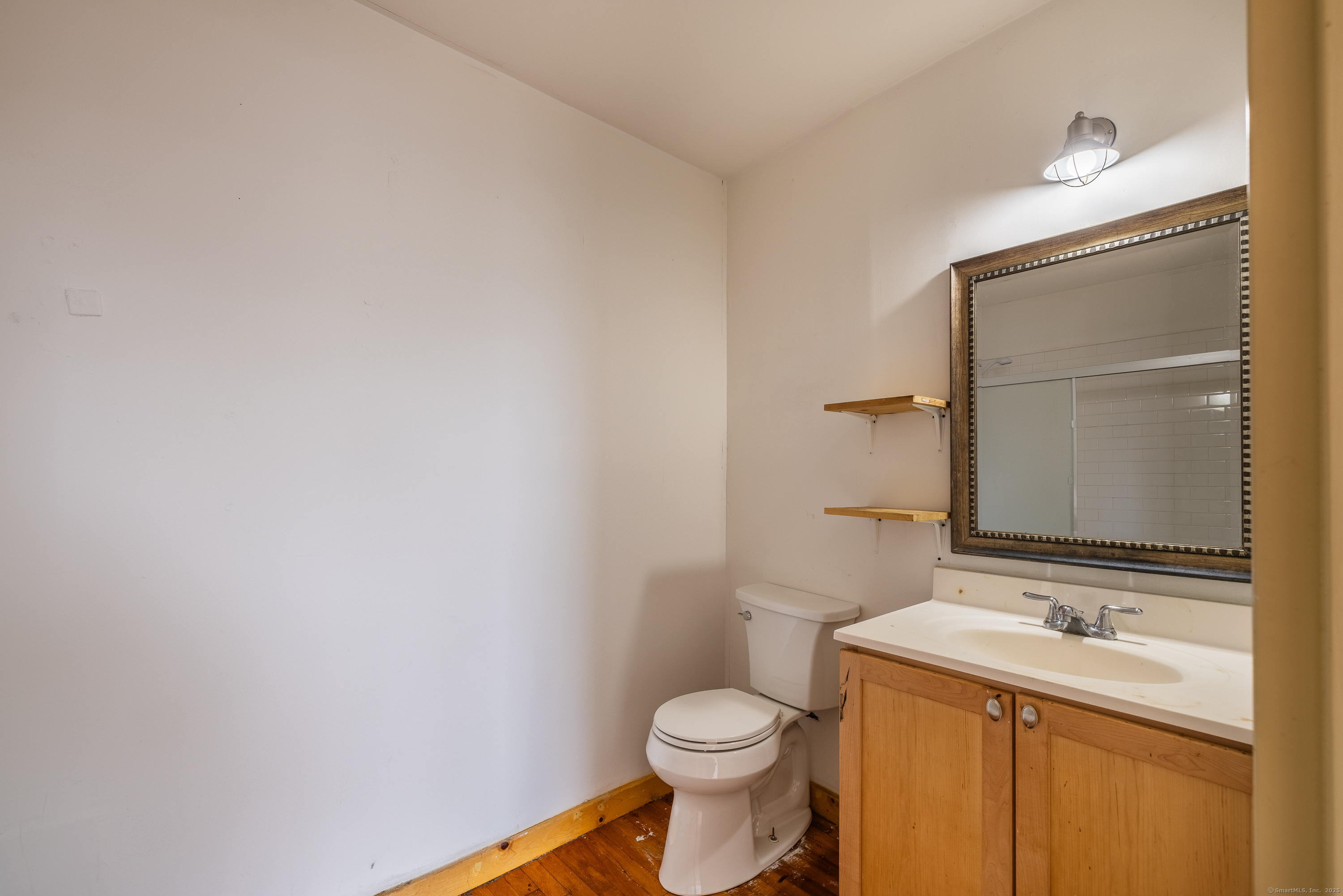 325 Lafayette Street, Unit 8102 Bridgeport, CT 06604 - Photo 11 of 19 a bathroom with a sink a toilet and mirror