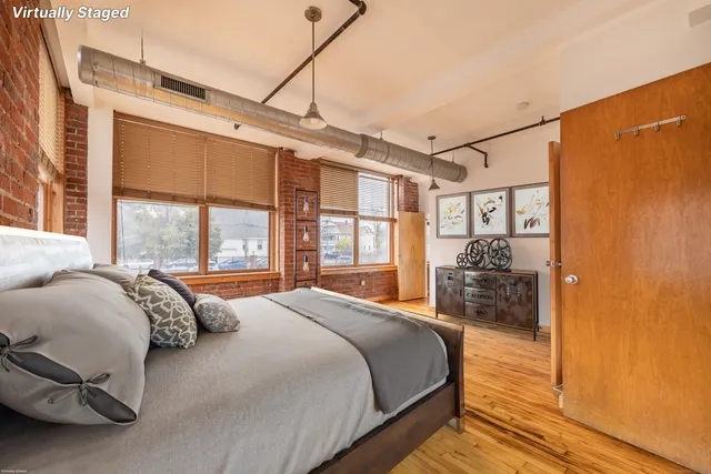 a bedroom with a large bed and a large window
