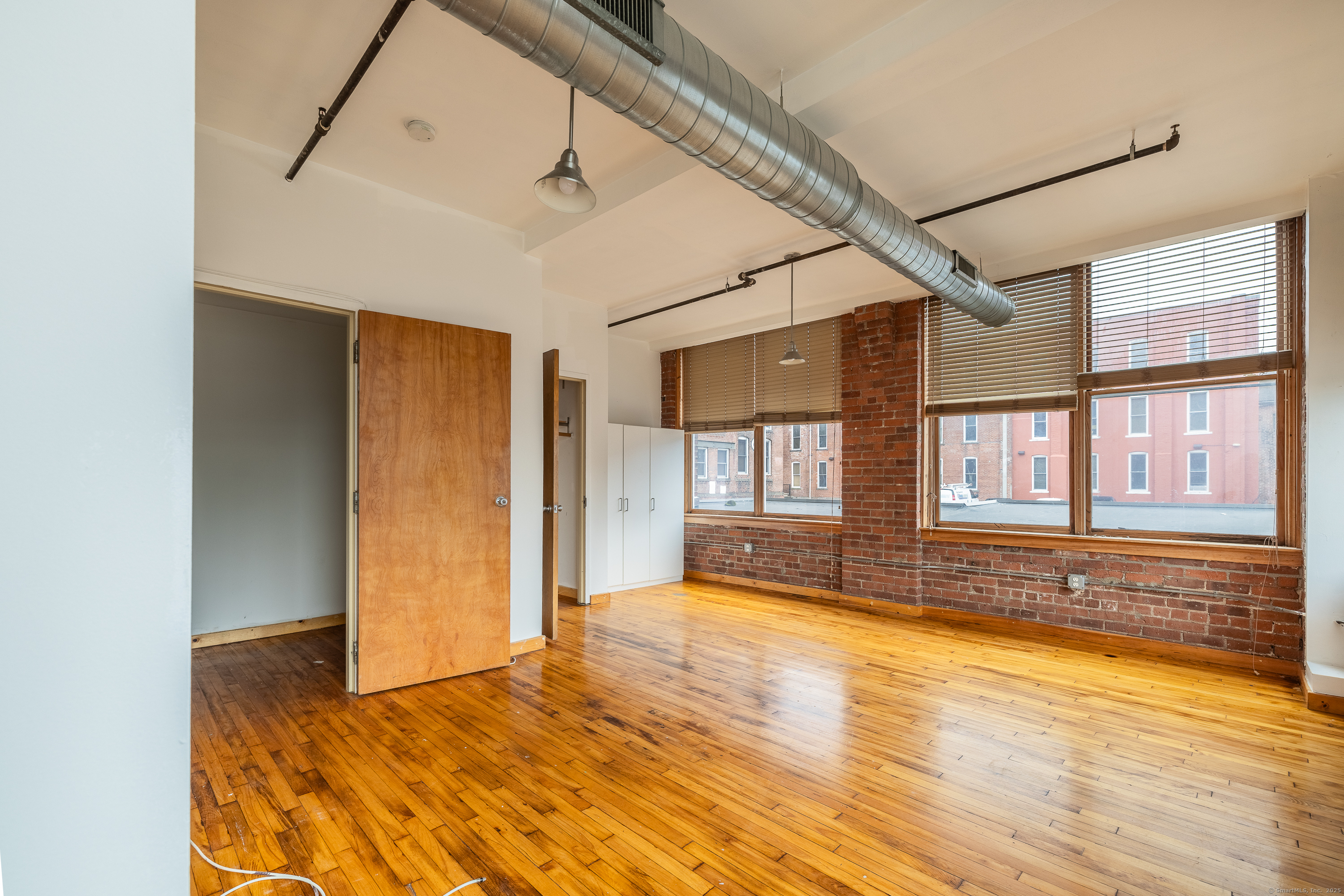 325 Lafayette Street, Unit 8102 Bridgeport, CT 06604 - Photo 15 of 19 a view of an empty room with window and wooden floor