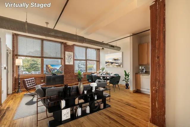a living room with furniture floor to ceiling windows and wooden floor