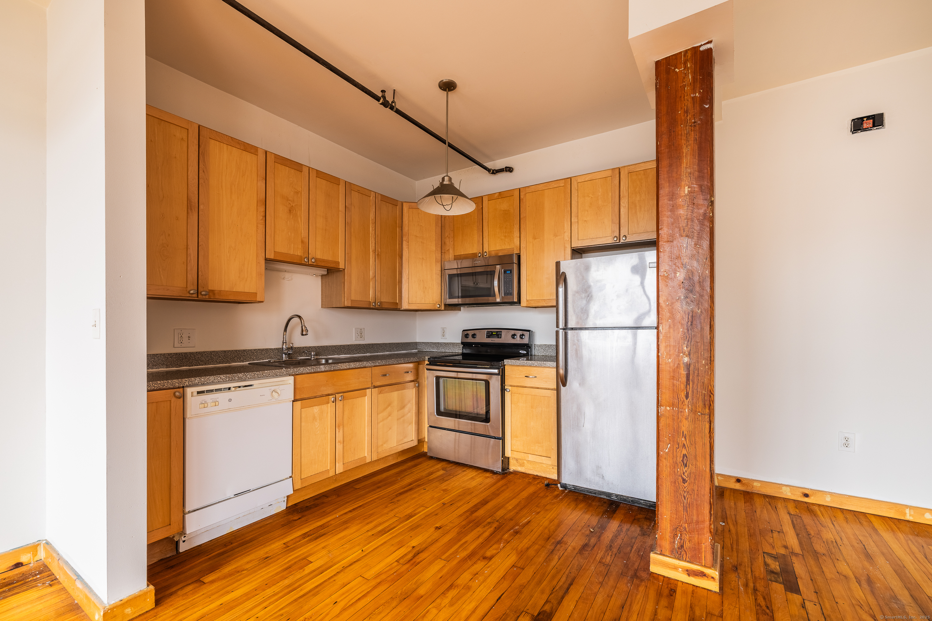 325 Lafayette Street, Unit 8102 Bridgeport, CT 06604 - Photo 8 of 19 a kitchen with stainless steel appliances granite countertop a refrigerator a stove top oven a sink and dishwasher with wooden floor