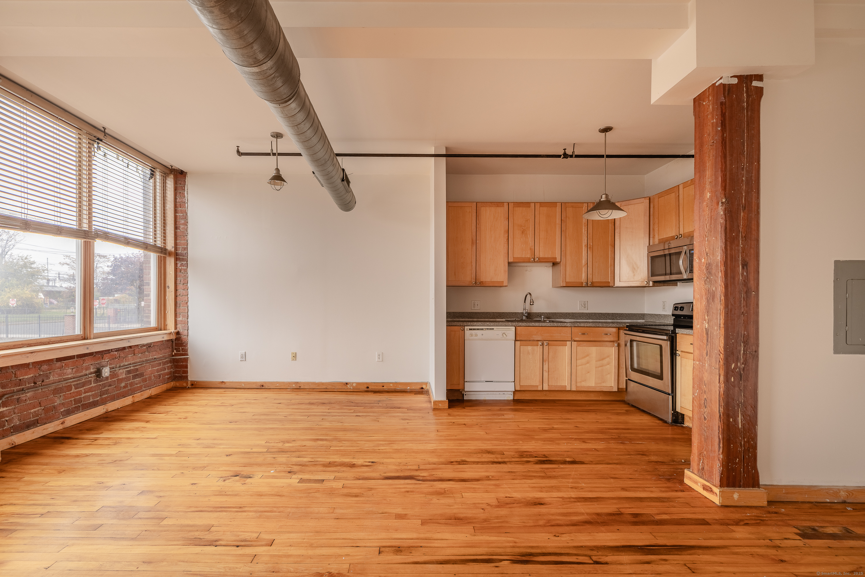 325 Lafayette Street, Unit 8102 Bridgeport, CT 06604 - Photo 10 of 19 a view of a kitchen with wooden floor and a window