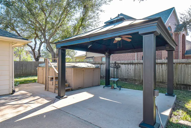 a view of a backyard with large tree