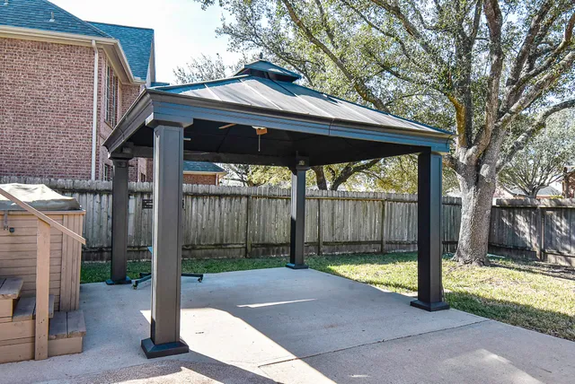 a view of a house with backyard porch and sitting area