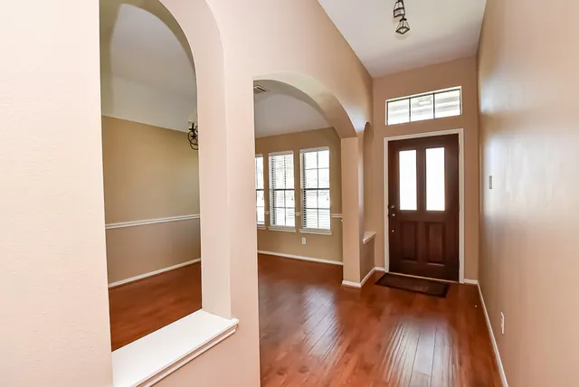 a view of an entryway with wooden floor