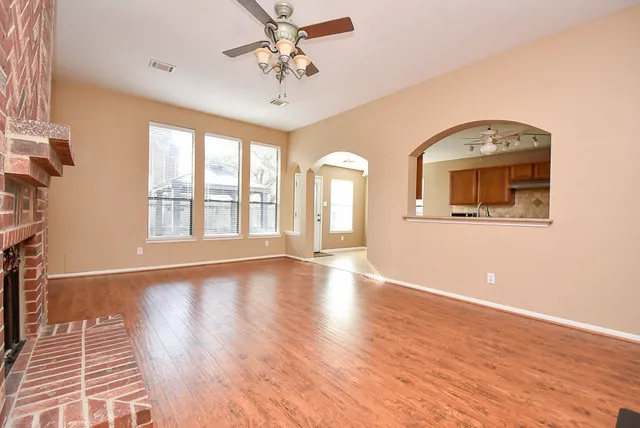 wooden floor in an empty room with a window