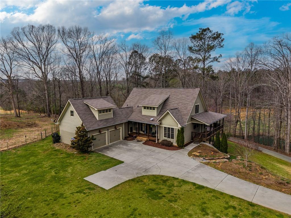 723 Sulphur Springs Road Southeast Fairmount, GA 30139 - Photo 2 of 54 an aerial view of a house with swimming pool and trees