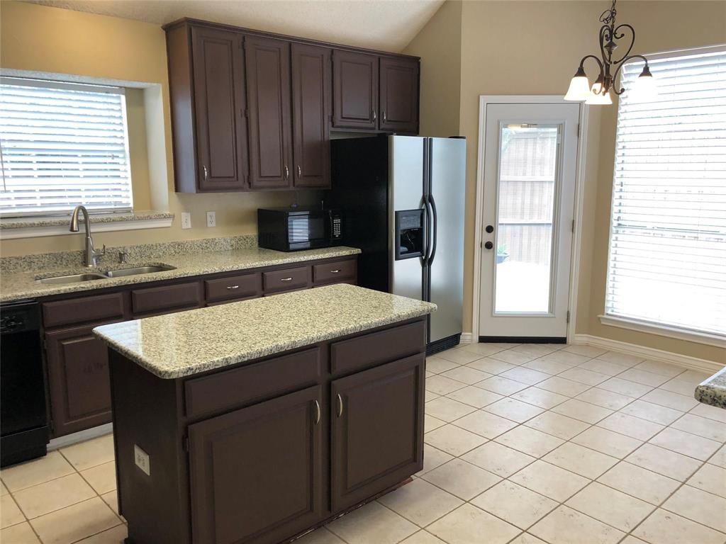 8301 Bells Street Frisco, TX 75035 - Photo 10 of 24 a kitchen with a sink a refrigerator and cabinets