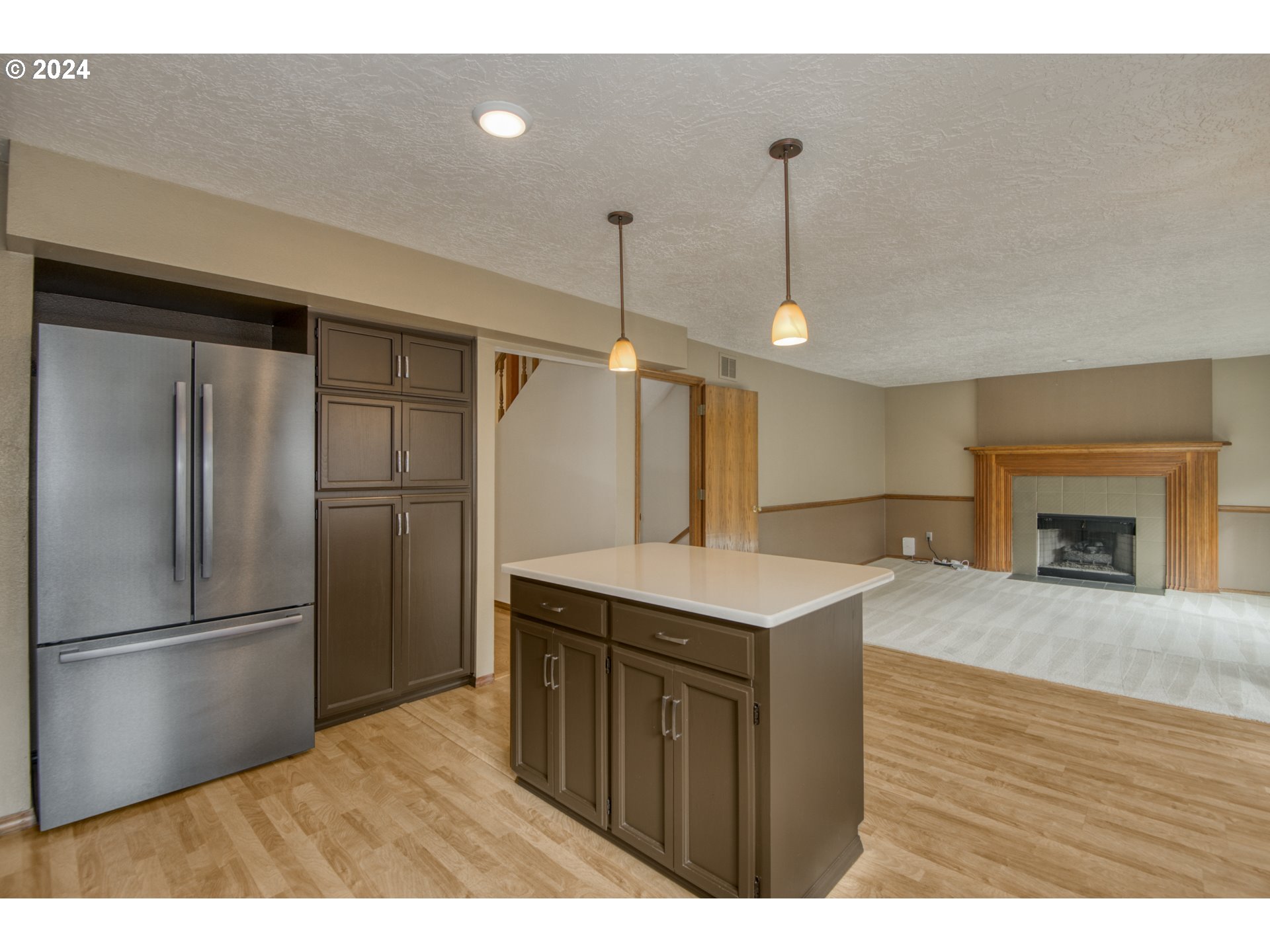 612 Southeast Lovrien Place Gresham, OR 97080 - Photo 12 of 48 a kitchen with a refrigerator a sink and a wooden floor