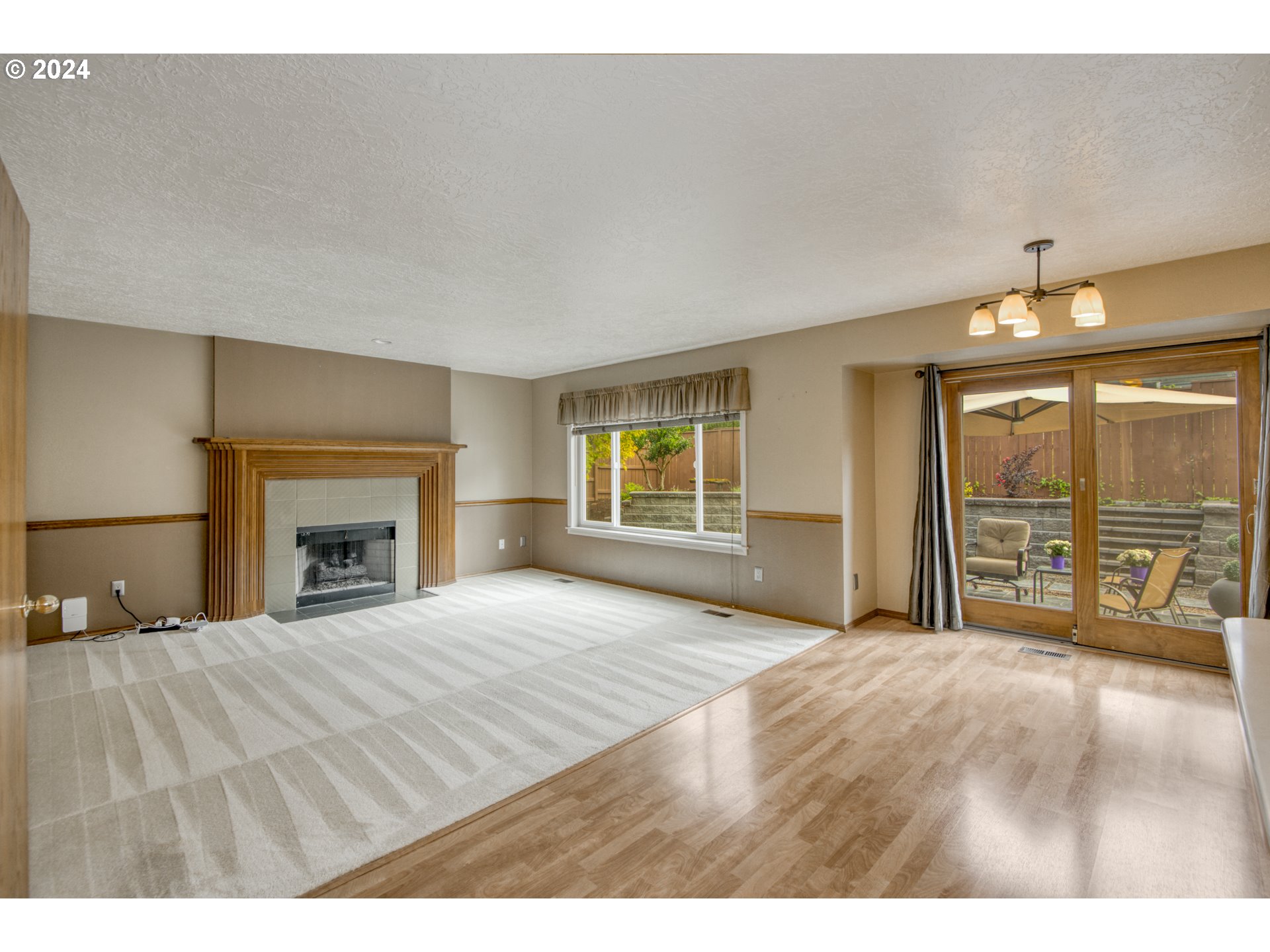 612 Southeast Lovrien Place Gresham, OR 97080 - Photo 13 of 48 a view of an empty room with a fireplace and a large window