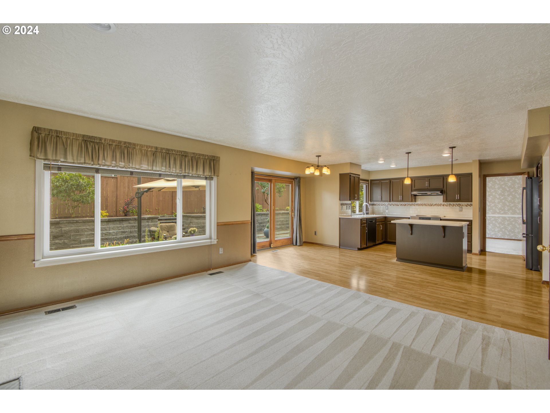 612 Southeast Lovrien Place Gresham, OR 97080 - Photo 16 of 48 a view of an empty room with kitchen and a window