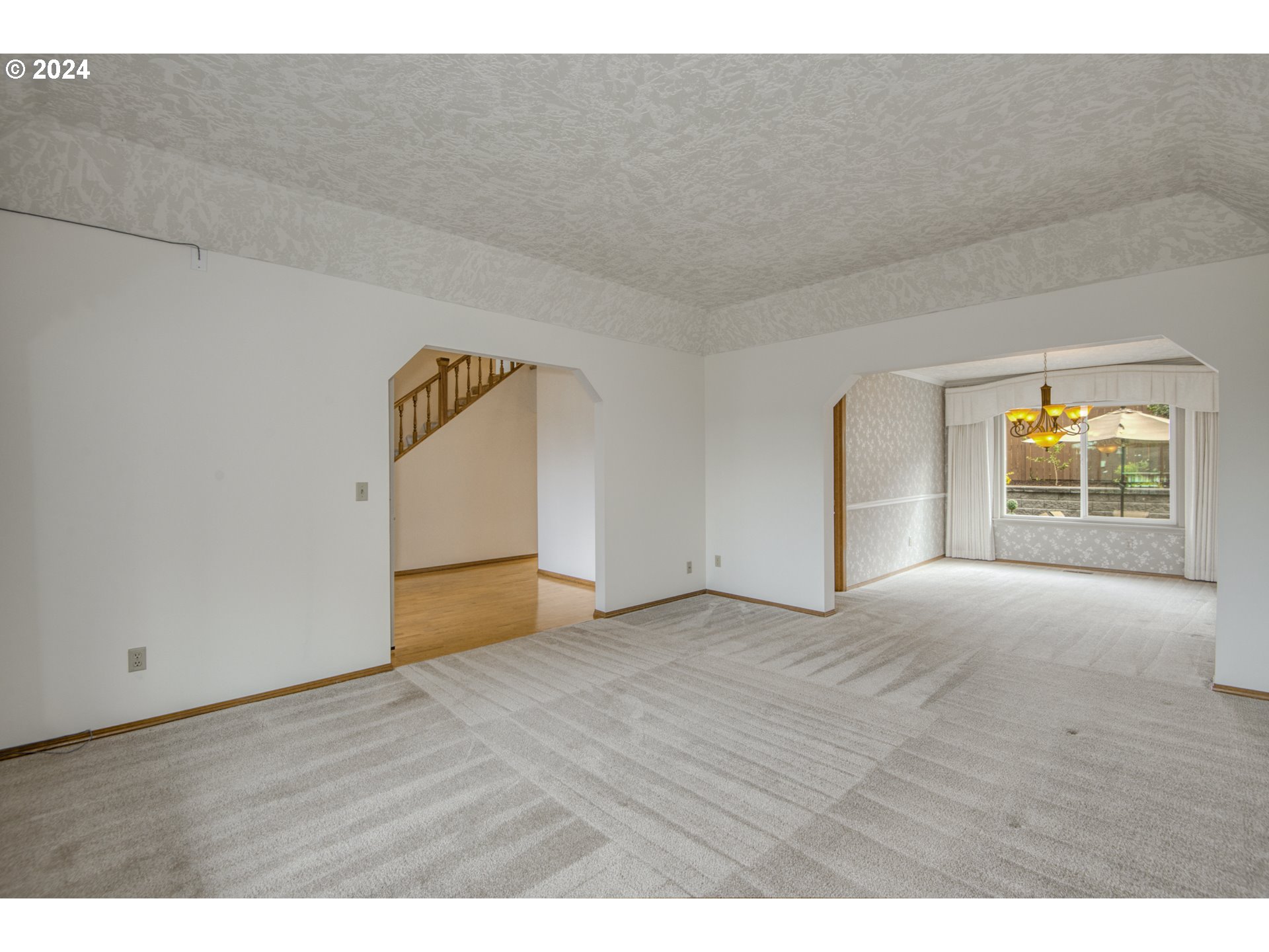612 Southeast Lovrien Place Gresham, OR 97080 - Photo 5 of 48 a view of an empty room with wooden floor and a window
