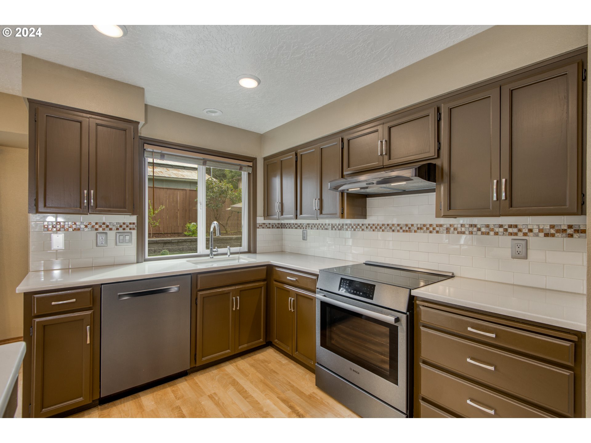 612 Southeast Lovrien Place Gresham, OR 97080 - Photo 8 of 48 a kitchen with stainless steel appliances granite countertop a stove sink and cabinets