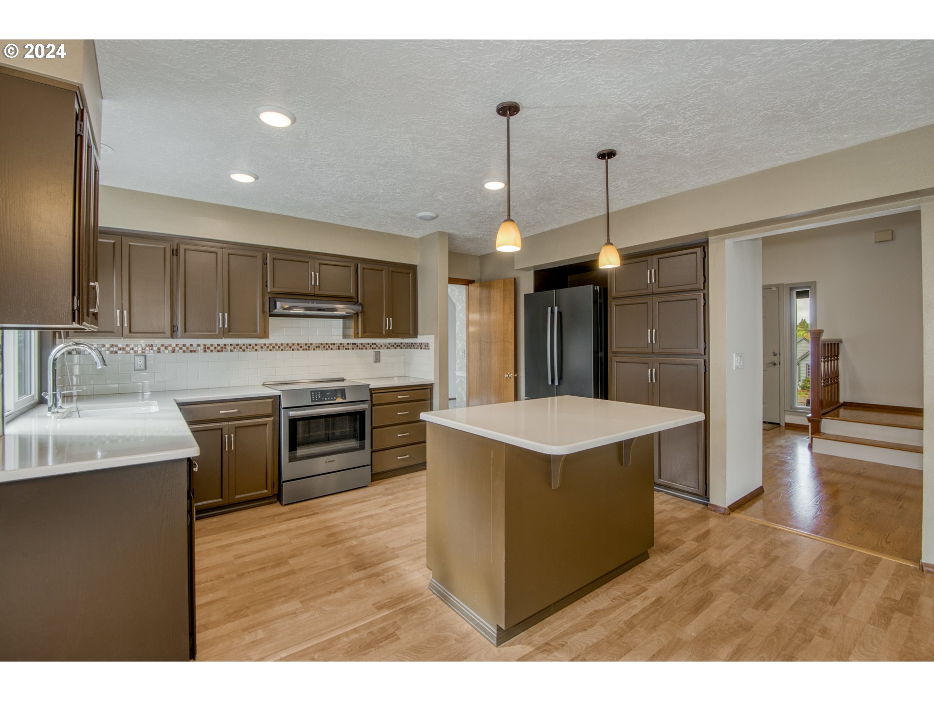 612 Southeast Lovrien Place Gresham, OR 97080 - Photo 9 of 48 a kitchen with kitchen island a sink stainless steel appliances and cabinets