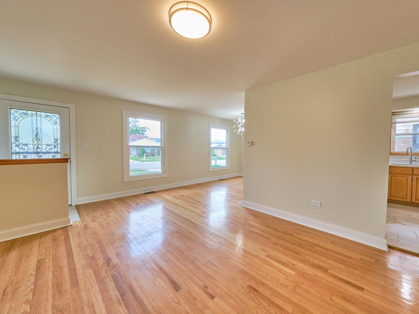 18207 Ravisloe Terrace Country Club Hills, IL 60478 - Photo 3 of 24 an empty room with wooden floor and windows