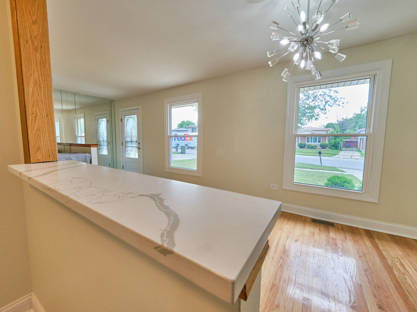 18207 Ravisloe Terrace Country Club Hills, IL 60478 - Photo 7 of 24 a spacious en suite bathroom with a granite countertop sink a large mirror and a window