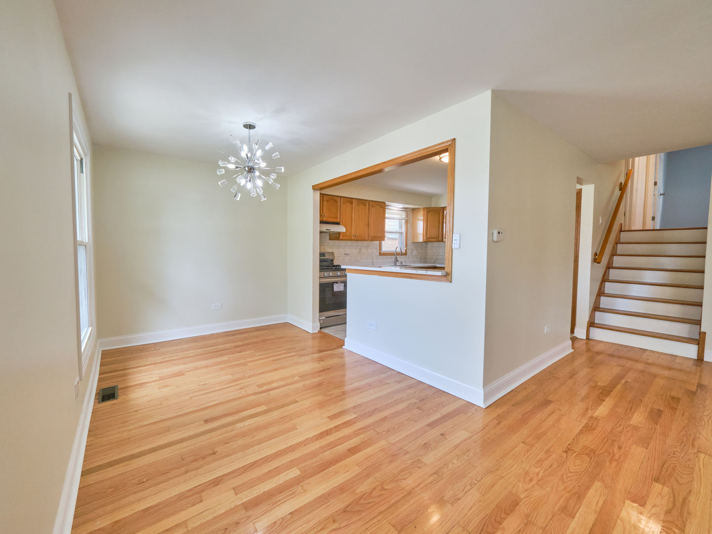 18207 Ravisloe Terrace Country Club Hills, IL 60478 - Photo 8 of 24 a view of a room with wooden floor and staircase