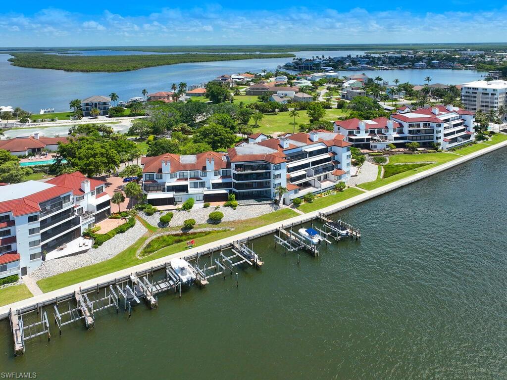 324 La Peninsula Boulevard, Unit 324 Naples, FL 34113 - Photo 27 of 35 a view of a city with an ocean house