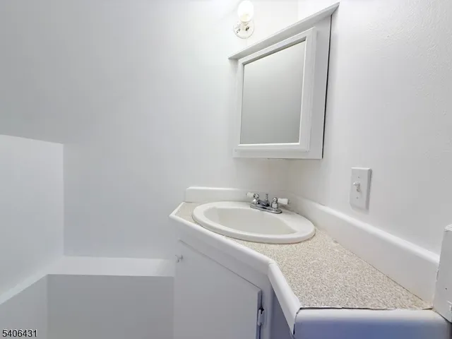 a car parked in front of a house with a yard