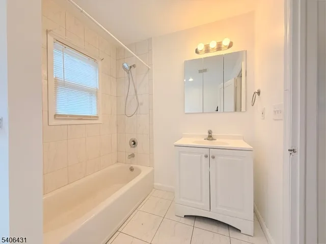 a bathroom with a granite countertop sink a toilet and bathtub