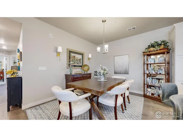 a kitchen with a table chairs refrigerator and a sink